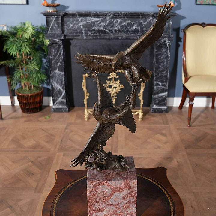 statue of two eagles fighting for prey