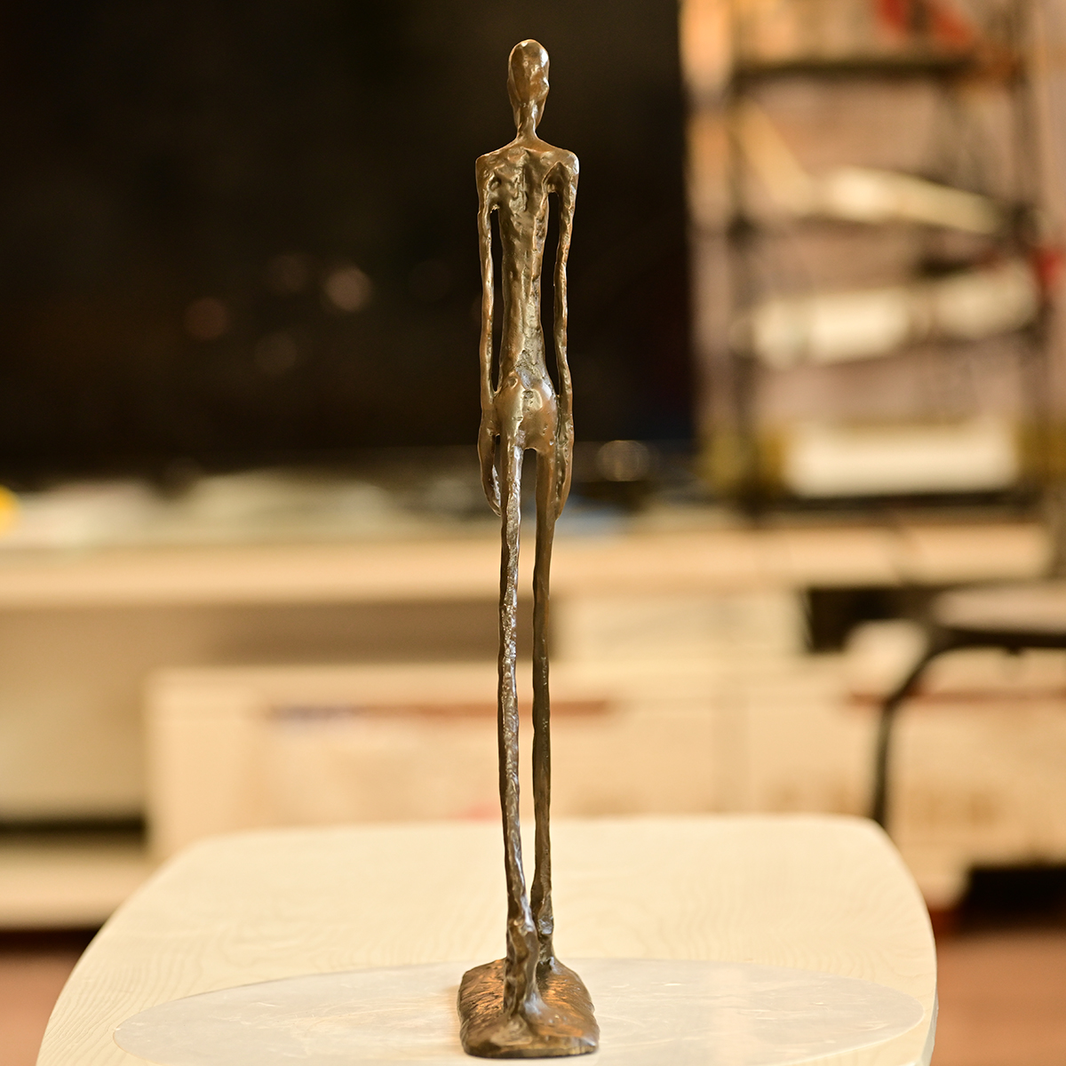 rearviewofbronzewalkingmanfigurine